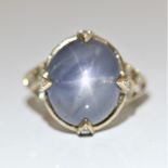 A star sapphire and diamond ring, set with a principal star sapphire cabochon, measuring approx.