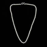 A string of pearls, clasp set with diamond accents and stamped 375, length approx. 18in.