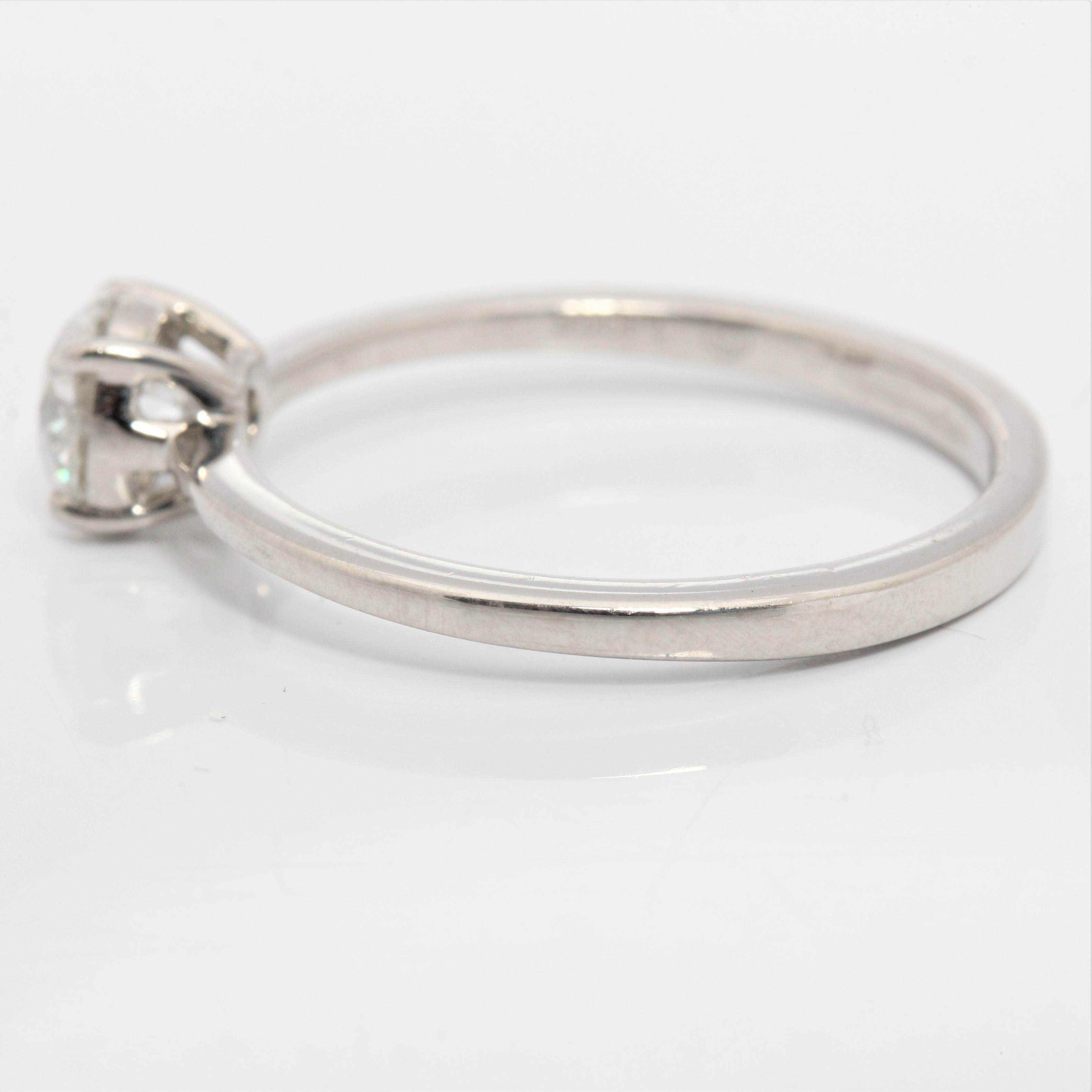 A hallmarked platinum diamond solitaire ring, set with a round brilliant cut diamond measuring - Image 4 of 4