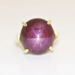 A star ruby ring, set with a star ruby cabochon, measuring approx. 22ct, to plain band, stamped