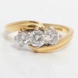 A hallmarked 18ct yellow gold diamond three stone ring, set with three graduated round brilliant cut