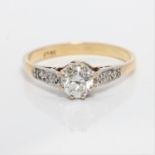 A diamond ring, set with a principal transitional cut diamond, measuring approx. 0.50ct, flanked