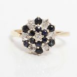 A hallmarked 9ct yellow gold diamond and sapphire tiered design cluster ring, ring size L