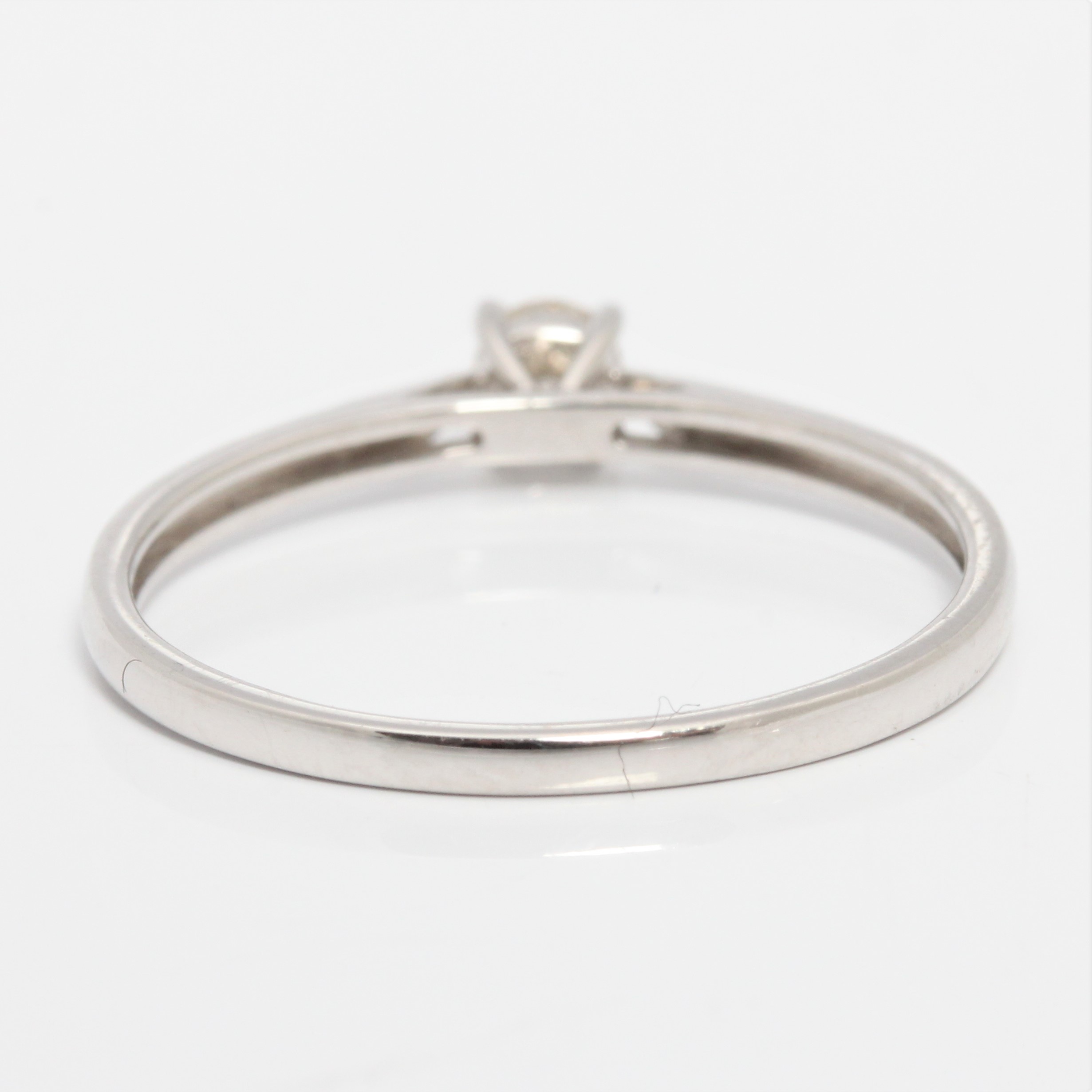 A hallmarked 9ct white gold diamond solitaire ring, set with a round brilliant cut diamond measuring - Image 3 of 4