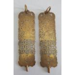 A pair of finely pierced oriental, brass panels with rings to top.