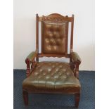 A late 19th century oak brown leather arm chair.