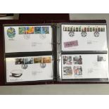 A collection of G B stamps on FDC,s 1974 to 2001 in four albums plus two coin covers.