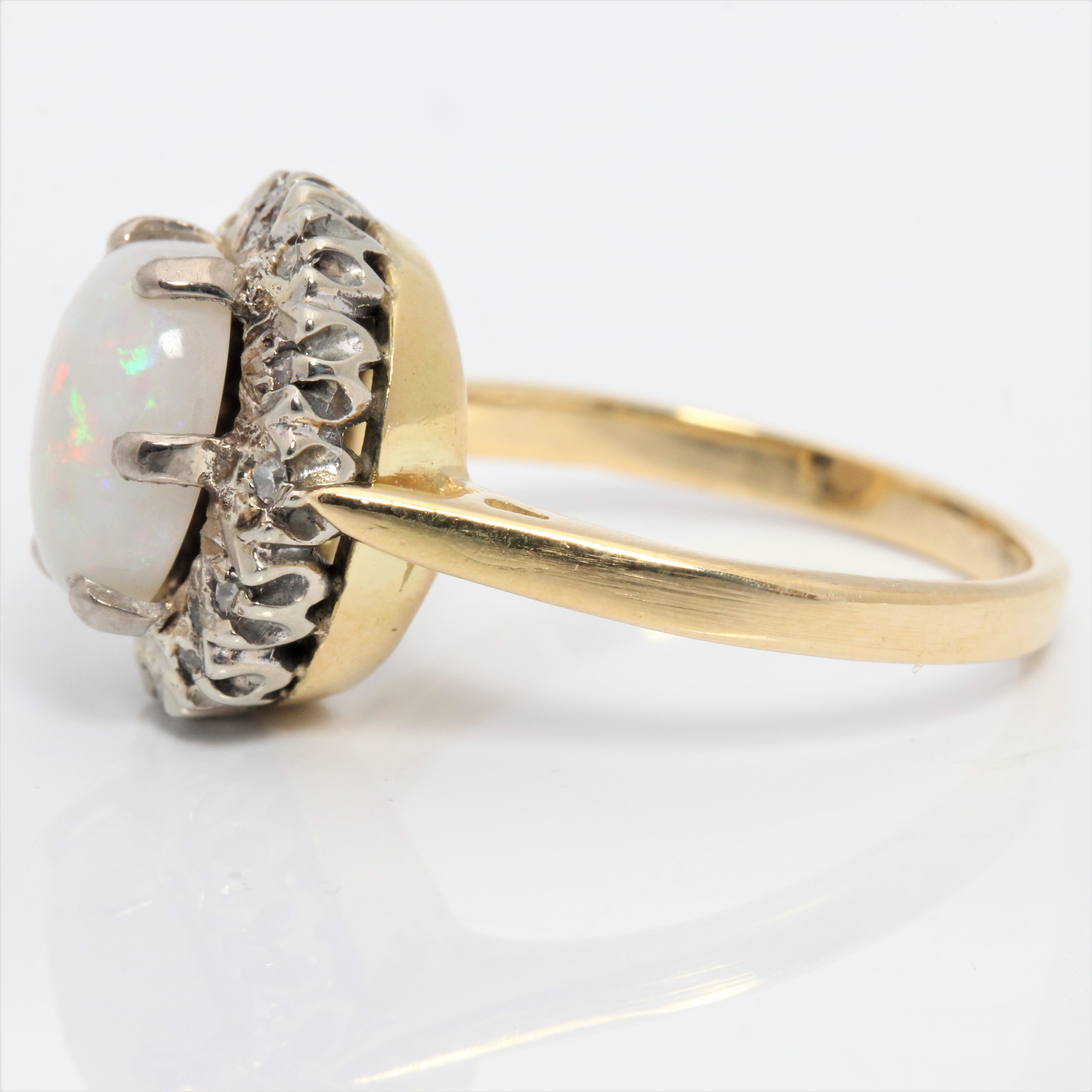 An opal and diamond cluster ring, set with an oval opal cabochon, measuring approx. 9x6mm, - Image 4 of 4