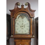 An oak and mahogany long-case mantle clock with revolving moon face, with weights and pendulum