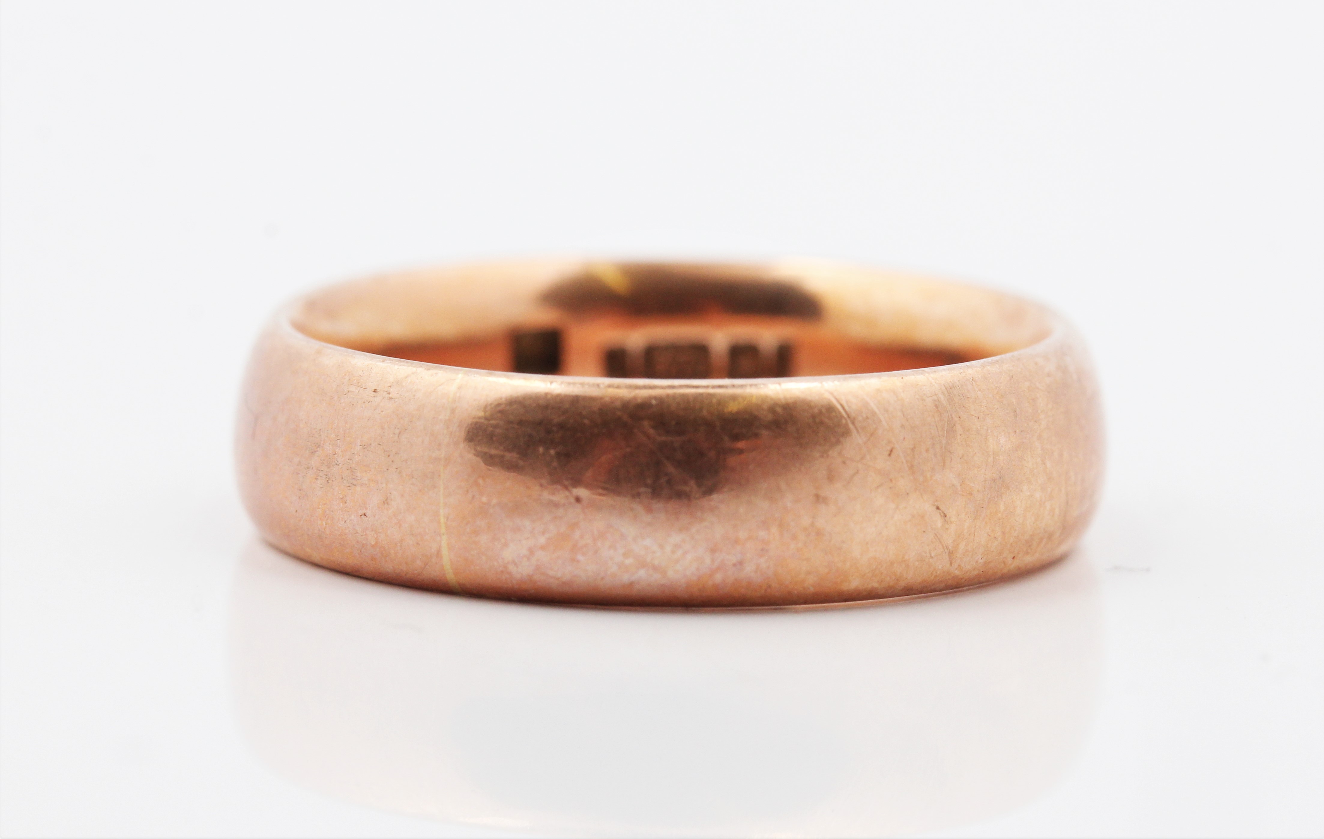 A hallmarked 9ct rose gold plain wedding band, ring size U, approx. weight 10.5g.