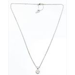 A hallmarked 18ct white gold diamond solitaire pendant, bezel set with a round brilliant cut diamond