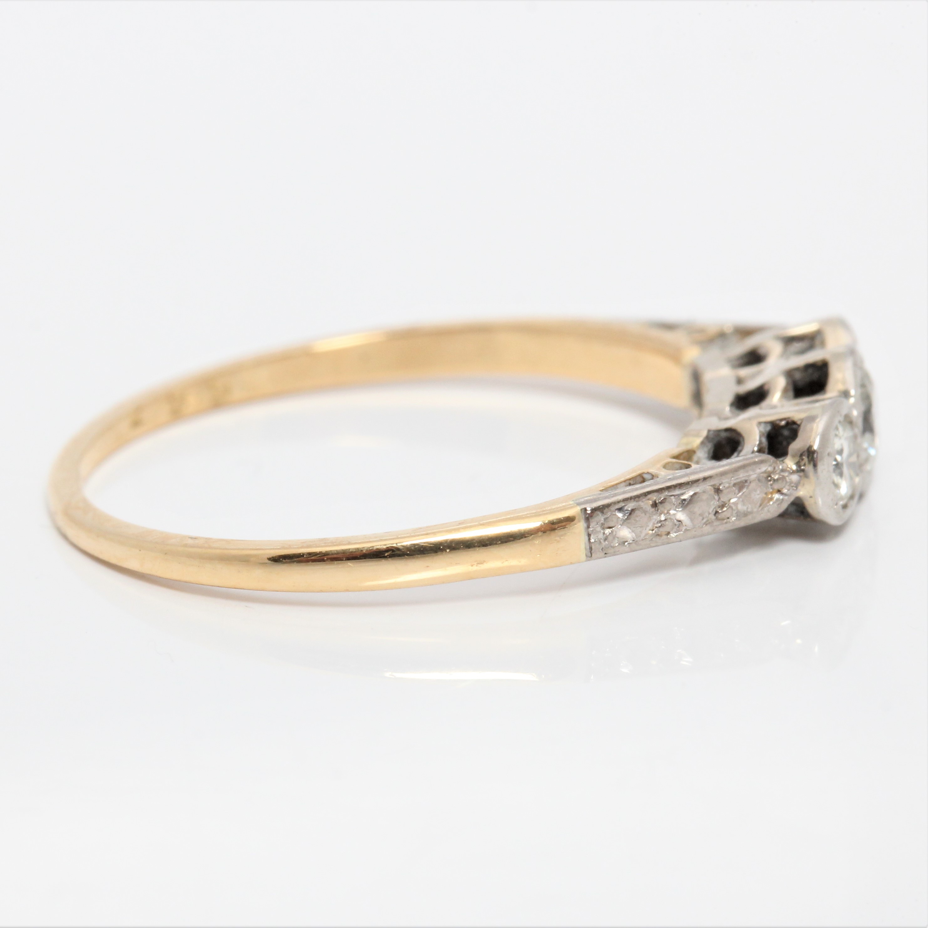 A hallmarked 18ct yellow gold three stone diamond ring, set with three graduated round brilliant cut - Image 2 of 4