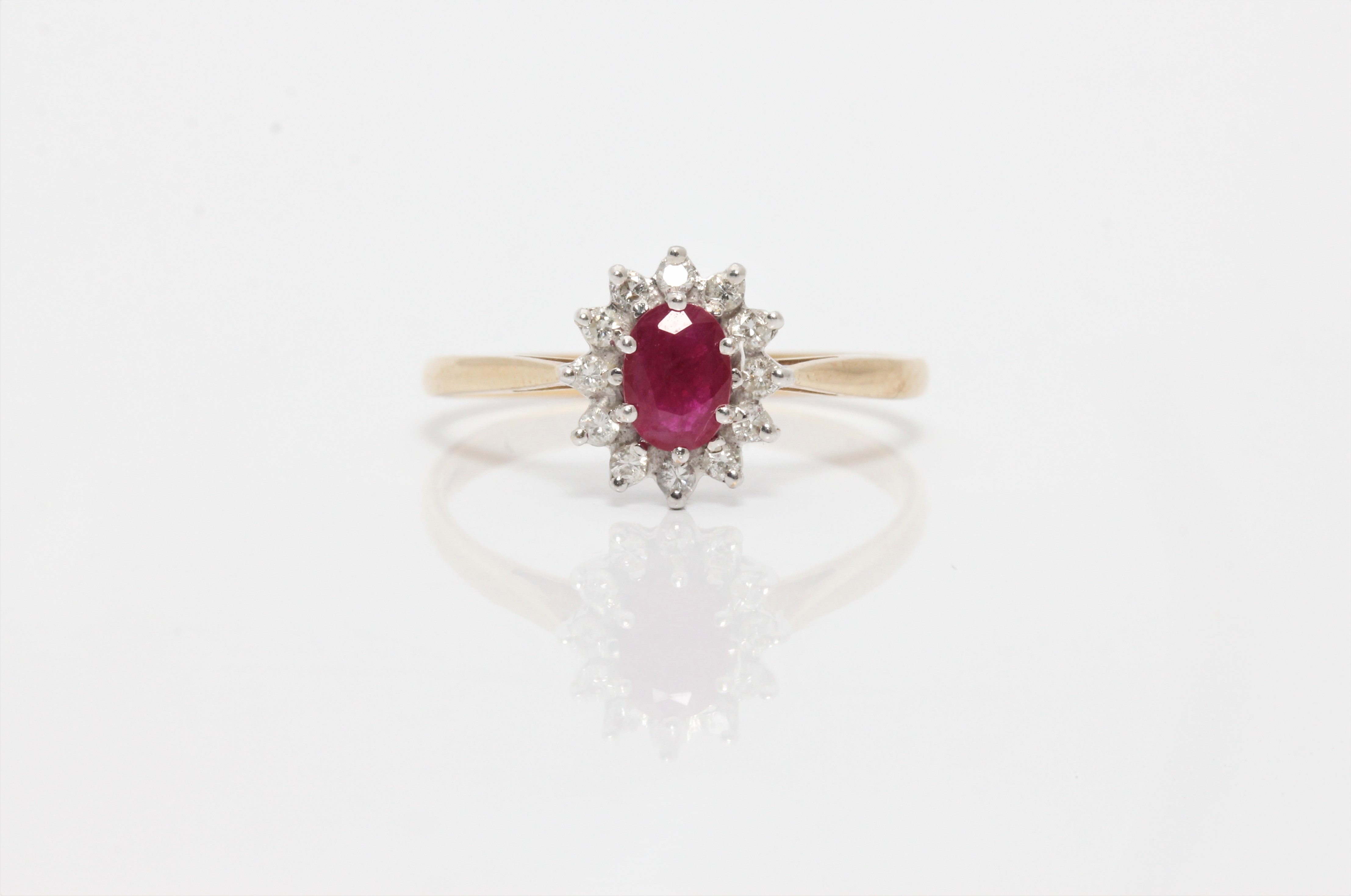 A hallmarked 9ct yellow gold ruby and diamond cluster ring, ring size Q1/2, approx. weight 1.9g.