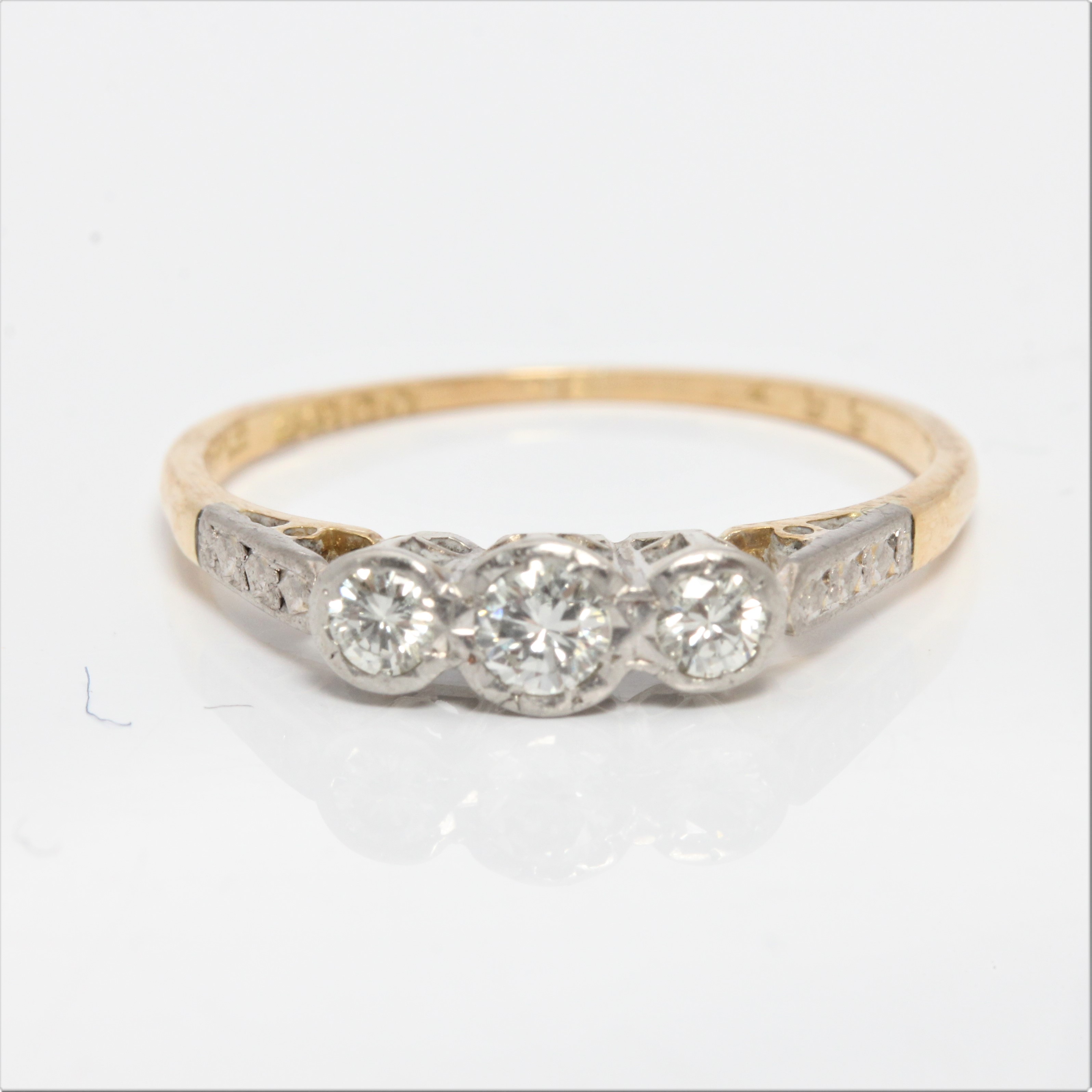 A hallmarked 18ct yellow gold three stone diamond ring, set with three graduated round brilliant cut
