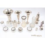 A collection of some hallmarked silverware, to include a flute shaped vase, two weighted candle