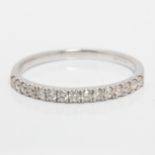 A hallmarked 9ct white gold diamond half eternity ring, set with fifteen round brilliant cut