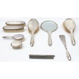 A hallmarked silver dressing table set, comprising of two hair brushes, a mirror, and two clothes