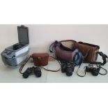 A collection of two Canon cameras, to include lens and accessories stored in carrying cases,