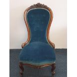 A 19th century walnut spoon back chair on cabriole supports in blue upholstery.