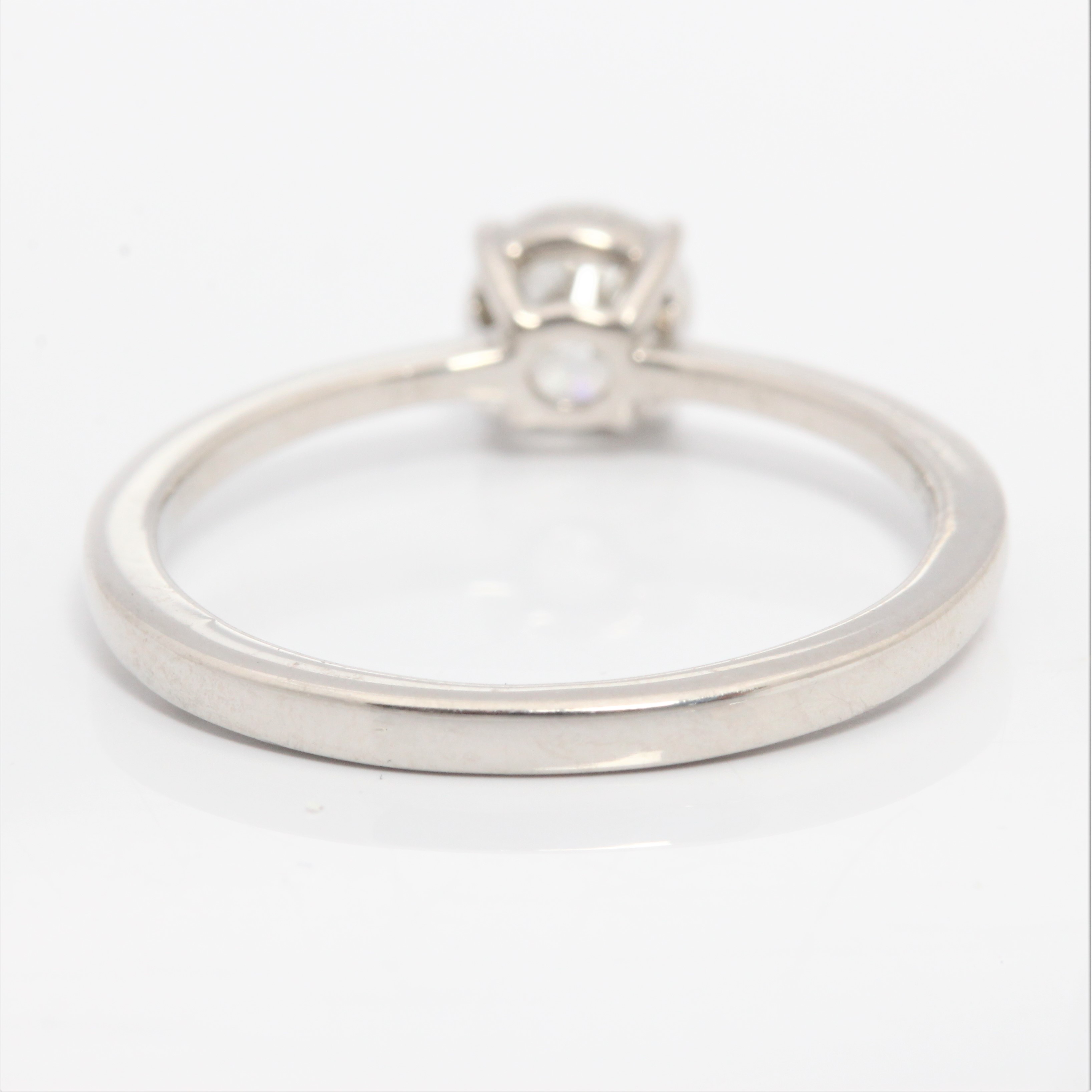 A hallmarked platinum diamond solitaire ring, set with a round brilliant cut diamond measuring - Image 3 of 4