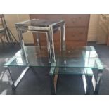 A Nest of Three Chrome and Smoke Glassed Coffee Tables together with a Large Chrome Coffee Table and