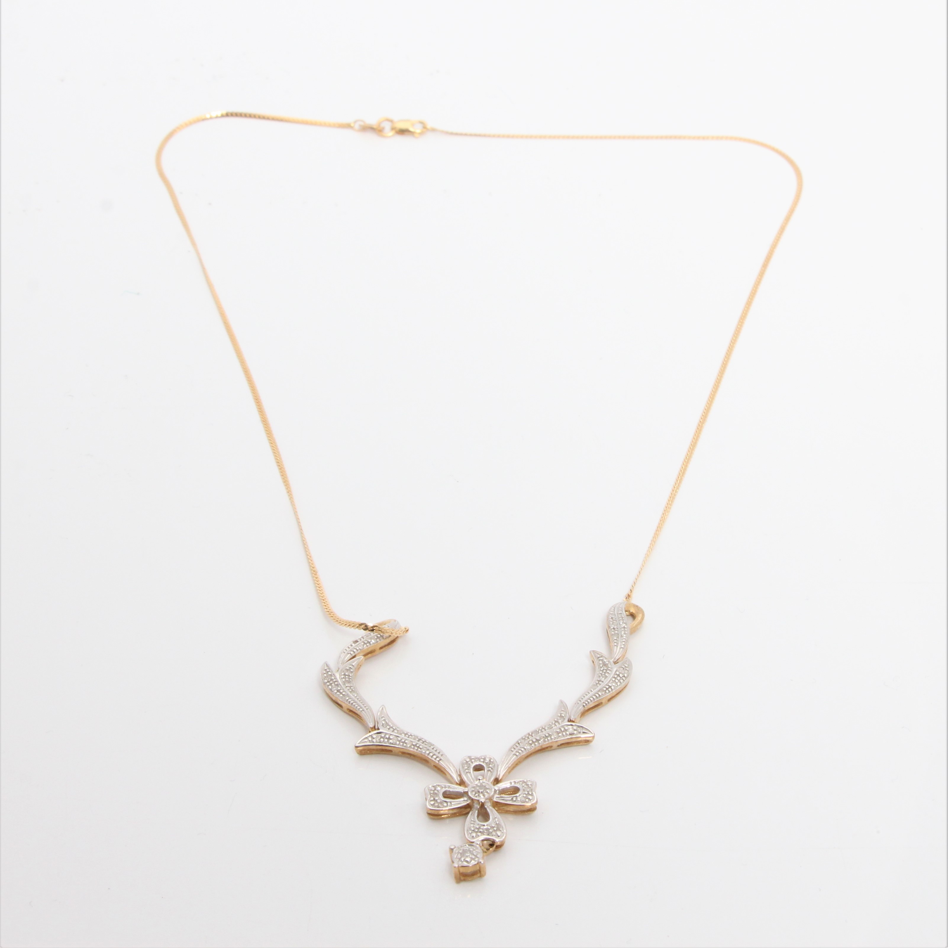 A diamond set necklet, the open metalwork floral and scroll leaf design set with diamond accents, - Image 3 of 3