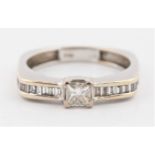 A hallmarked 18ct white gold diamond ring, set with a principal princess cut diamond measuring