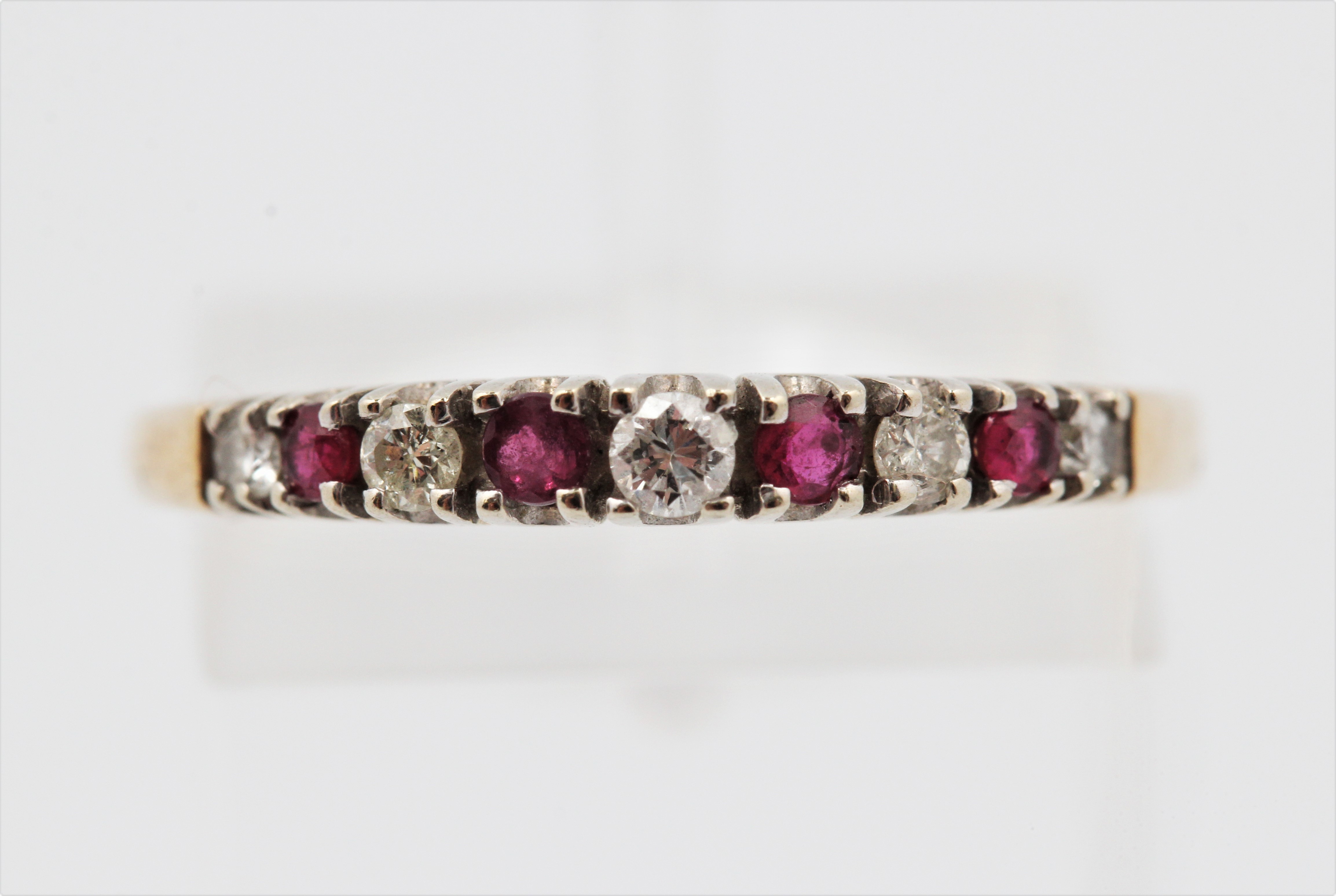 A hallmarked 9ct yellow gold ruby and diamond half eternity ring, ring size Q1/2, approx. weight 1.