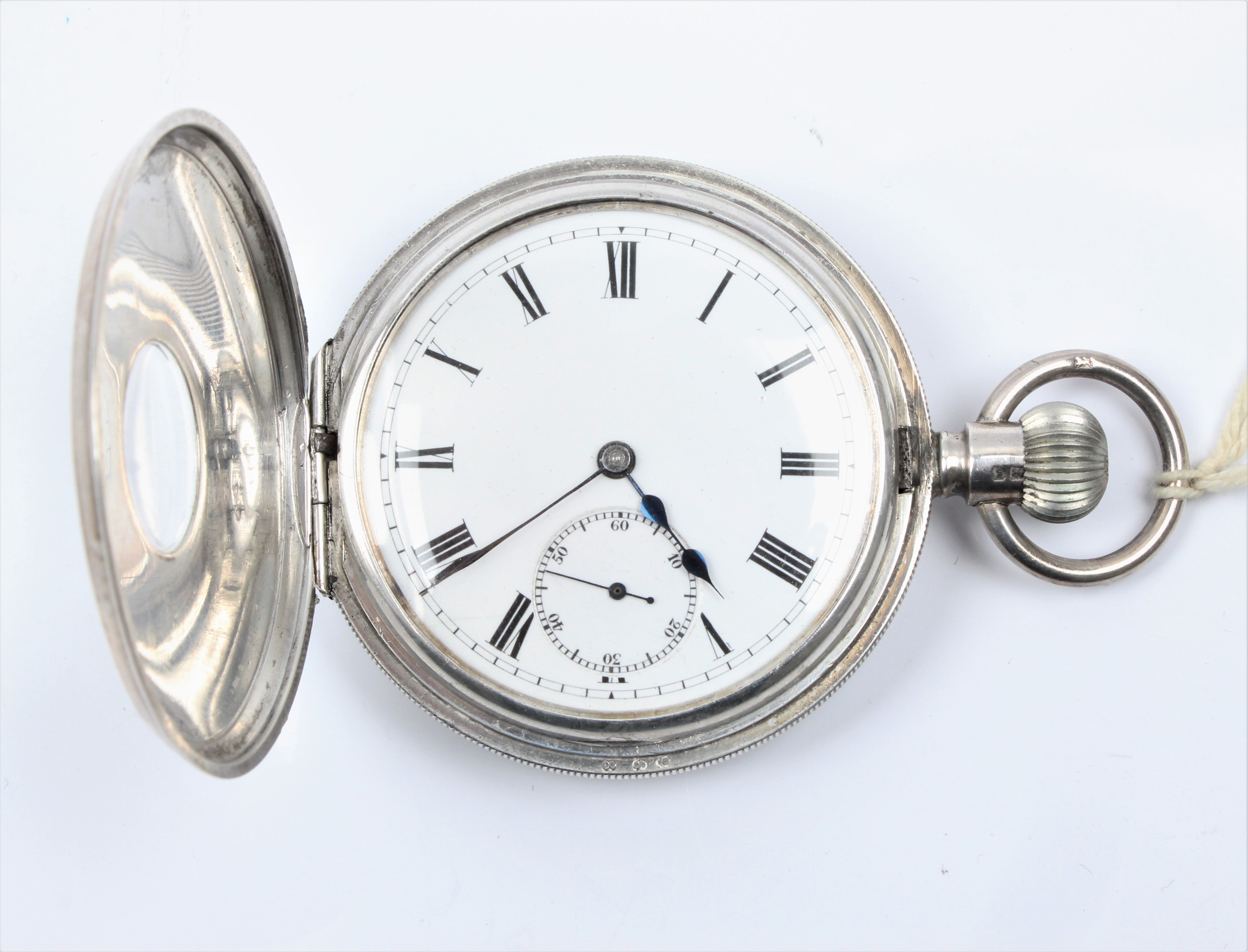 A silver crown wind half hunter pocket watch, the white enamel dial having hourly Roman numeral