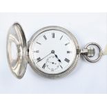 A silver crown wind half hunter pocket watch, the white enamel dial having hourly Roman numeral