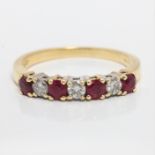 A hallmarked 18ct yellow gold ruby and diamond half eternity ring, set with four round cut rubies