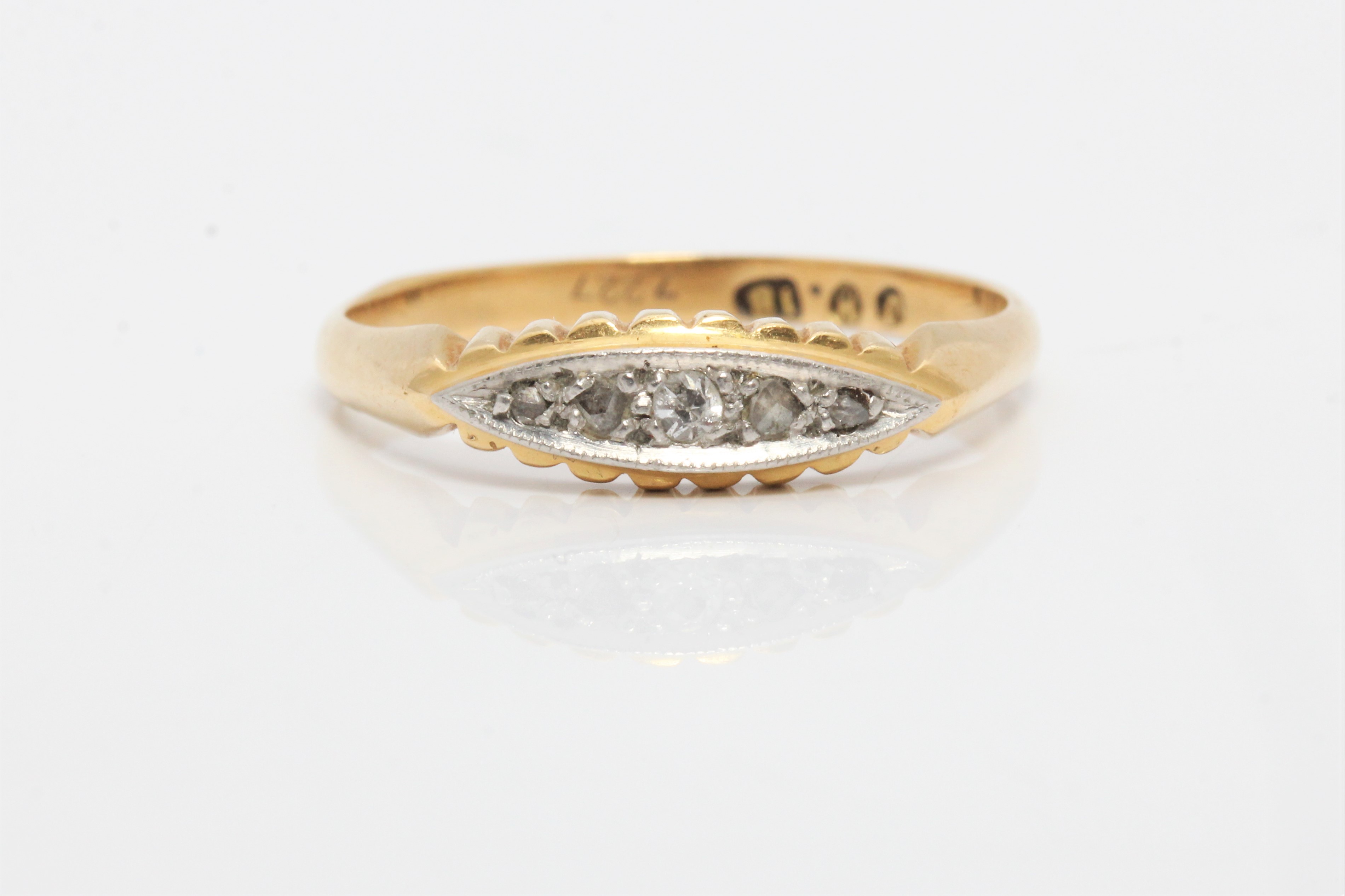 A five stone diamond ring, stamped 18, ring size P.