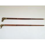 Two walking canes, Horse head unscrews revealing snuff container, Duck head unscrews revealing