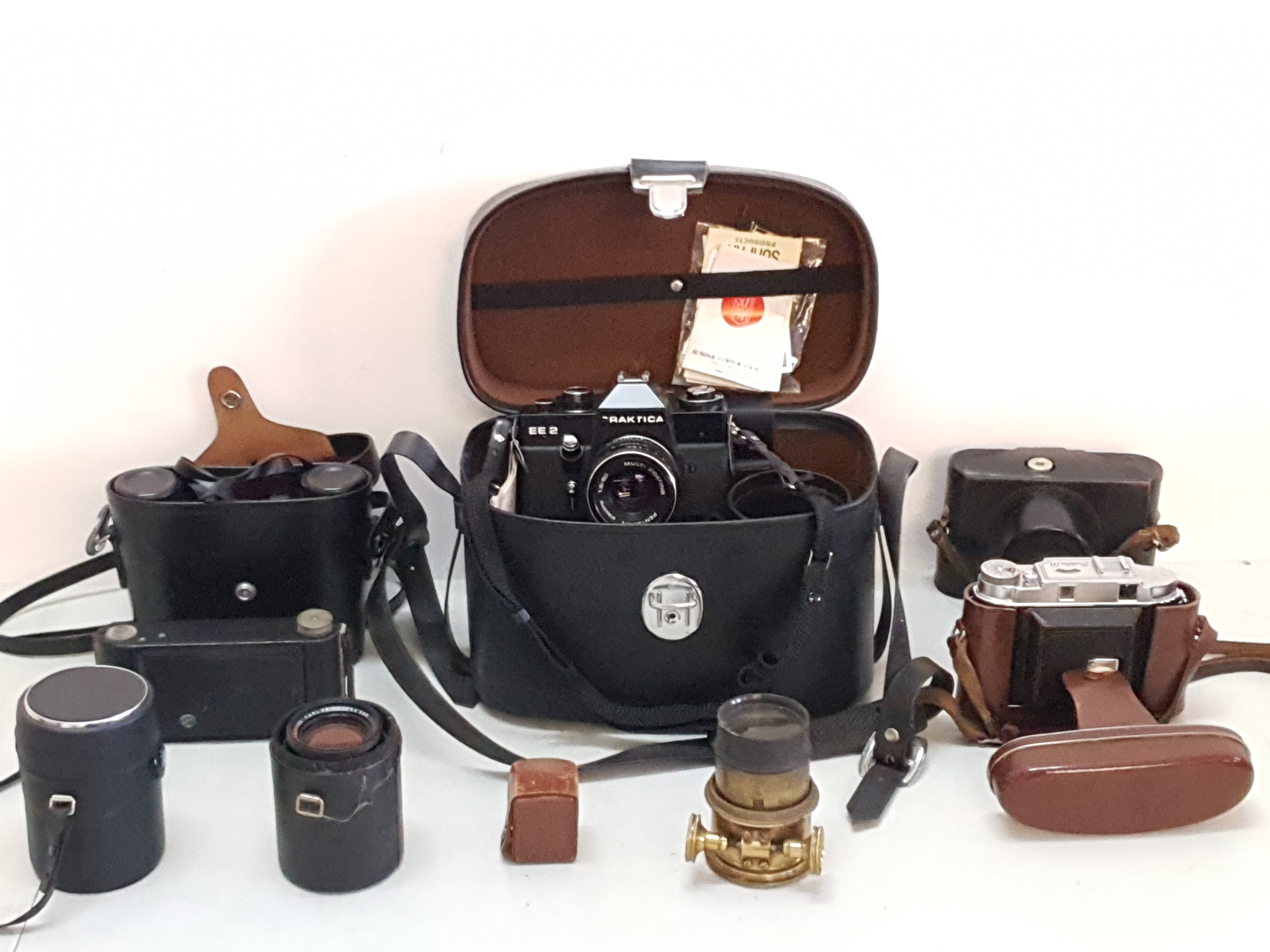 A collection of cameras and optical gear to include, a pair of Panda Binoculars, Praktica EE2,