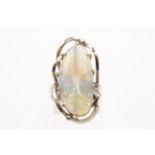 An opal dress ring, set with an opal cabochon measuring approx. 26x13mm, surrounded by an open