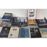 An assortment of Commemorative Coins and incomplete collector booklets.