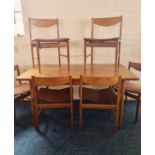 A G plan teak extending dining table and six brown upholstered chairs