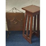 A mahogany arts and crafts pierced side plant stand together with a hand-beaten fire screen.