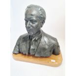 A large bronze bust of a gentlemen wearing suit and tie on wooden base, approx. height 53cm