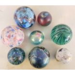 A collection of glass paperweights to include Isle Of Wight Glass.