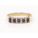 A hallmarked 9ct yellow gold sapphire and diamond ring, set with five baguette cut sapphires each