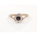 A hallmarked 9ct yellow gold sapphire and diamond cluster ring, set with a central round cut