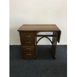 A small oak, four-drawer desk.