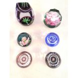A collection of six Caithness paperweights to include three limited editions.
