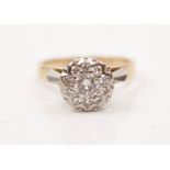 A diamond cluster ring, set with a principal round brilliant cut diamond measuring approx. 0.35ct,