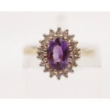 A hallmarked 9ct yellow gold amethyst and diamond cluster ring, ring size I