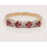 A hallmarked 9ct yellow gold ruby and diamond half eternity ring, set with four round cut rubies