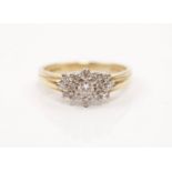A hallmarked 18ct yellow gold diamond cluster ring, set with a principal round brilliant cut diamond