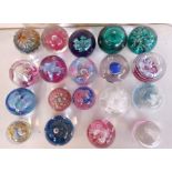 A collection of glass paperweights to include Caithness.