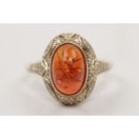A fire opal and diamond ring, set with a central oval fire opal cabochon, measuring approx.